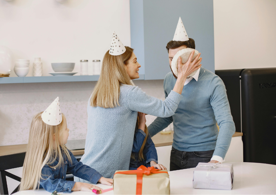 woman puts cream pie in man's face for gift