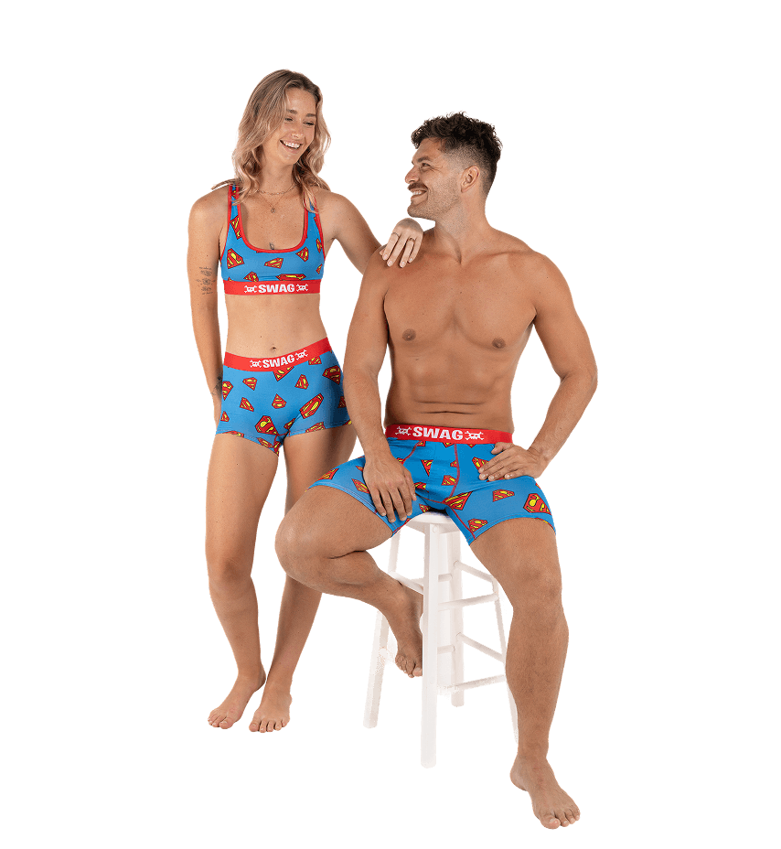 Smiling couple wearing matching blue and red patterned underwear.