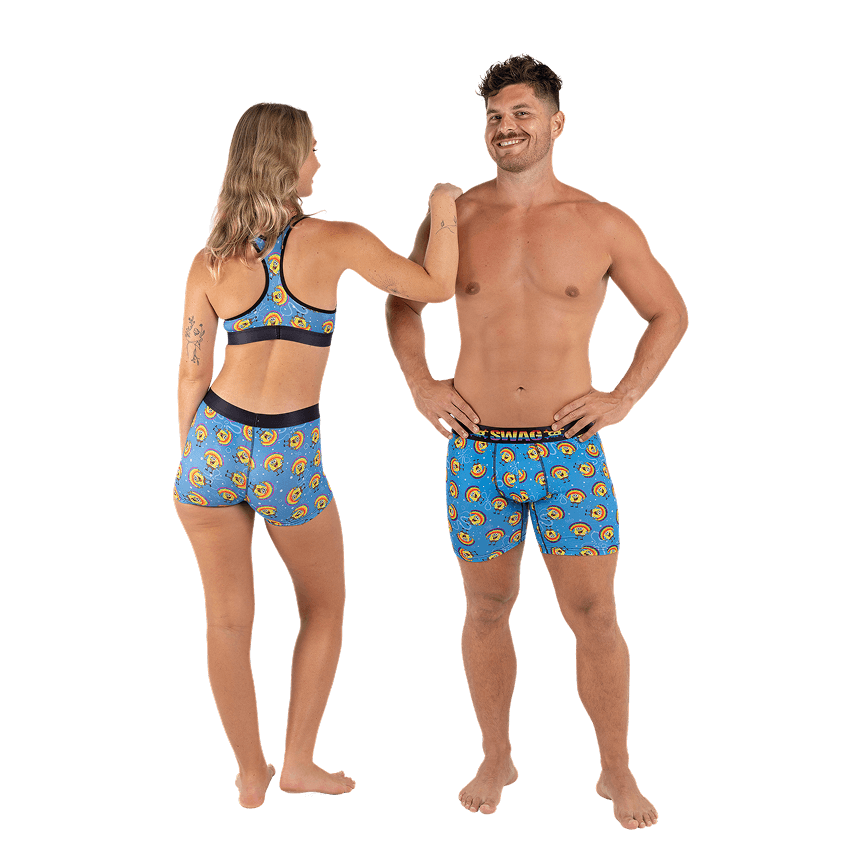 Two people in matching blue printed underwear sets, smiling.